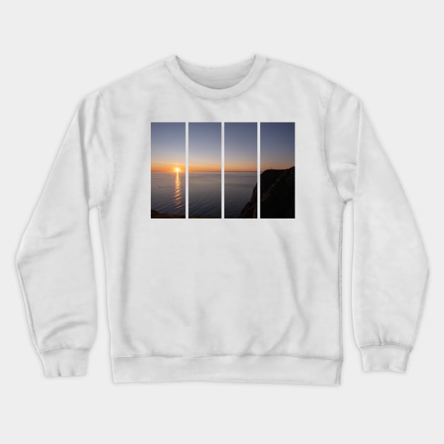 Wonderful landscapes in Norway. Nord-Norge. Beautiful scenery of a midnight sun sunset at Nordkapp (Cape North). Boat and globe on a cliff. Rippled sea and clear orange sky. Crewneck Sweatshirt by fabbroni-art
